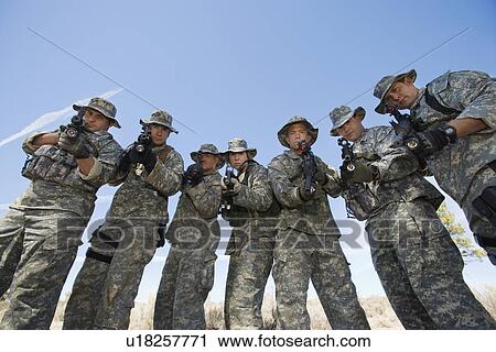 Group portrait of soldiers aiming guns View Large Photo Image Stock Image - Group portrait of soldiers aiming guns. Fotosearch