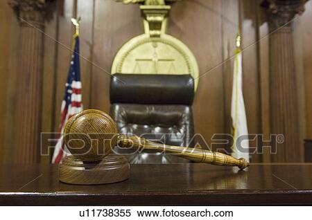 Stock Photography - Hammer and gavel near judges chair in court. Fotosearch