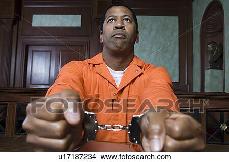 Handcuffed criminal in court View Large Photo Image Picture - Handcuffed criminal in court. Fotosearch
