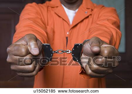 Stock Photography - Handcuffed criminal in court. Fotosearch