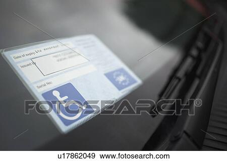 Stock Photo - Handicap sticker on windshield. Fotosearch
