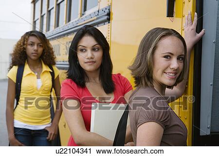 Stock Image - High School Girls Getting On School Bus. Fotosearch