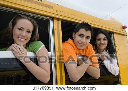 Stock Image - High School Students Looking Out Windows of School bus. Fotosearch