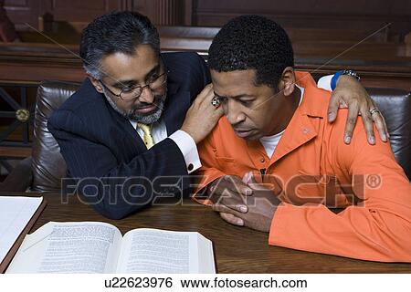 Lawyer embracing criminal in court View Large Photo Image Stock Photograph - Lawyer embracing criminal in court. Fotosearch