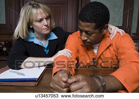 Stock Image - Lawyer with criminal in court. Fotosearch