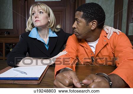 Stock Image - Lawyer with criminal in court. Fotosearch