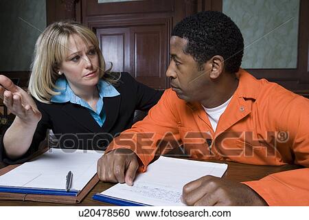 Stock Image - Lawyer with criminal in court. Fotosearch