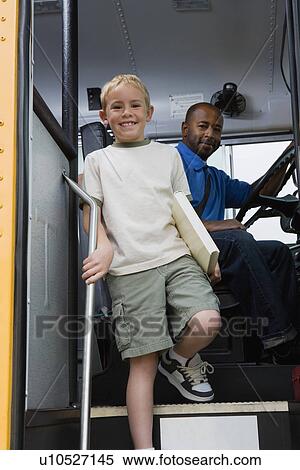 Stock Photography - Little Boy Getting off of Schoolbus. Fotosearch