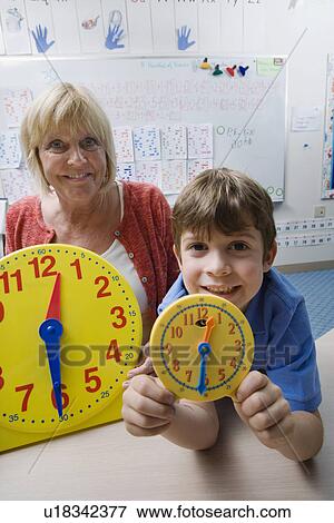 Stock Photo - Little Boy Learning to Tell Time. Fotosearch