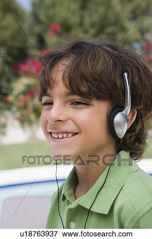 Stock Photo - Little Boy Listening to Headphones. Fotosearch