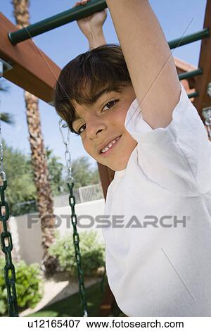 Stock Photo - Little Boy on a Jungle Gym. Fotosearch