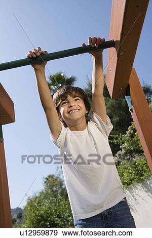 Stock Photo - Little Boy on a Jungle Gym. Fotosearch