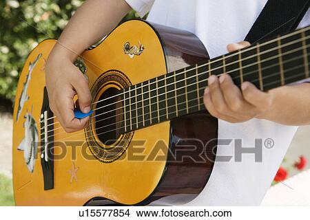 Picture - Little Boy Playing Guitar. Fotosearch