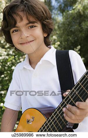 Stock Photograph - Little Boy Playing Guitar. Fotosearch