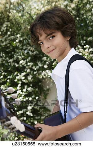 Stock Photography - Little Boy Playing Guitar. Fotosearch