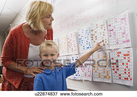 Little Boy Pointing to a Calendar Date for Teacher View Large Photo Image Stock Photo - Little Boy Pointing to a Calendar Date for Teacher. Fotosearch