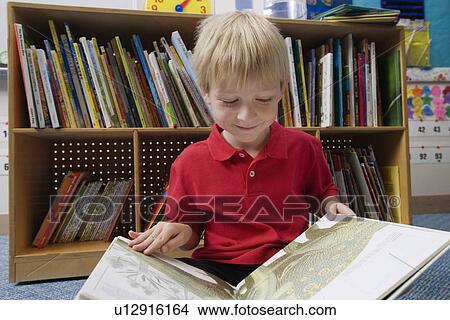Picture - Little Boy Reading a Picture Book. Fotosearch