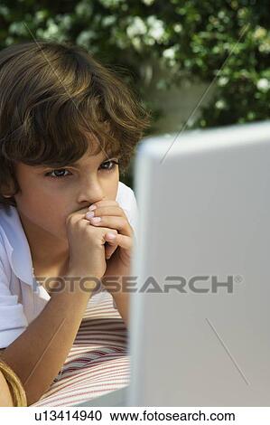 Stock Image - Little Boy Using a Laptop. Fotosearch