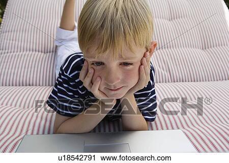 Stock Image - Little Boy Using a Laptop. Fotosearch