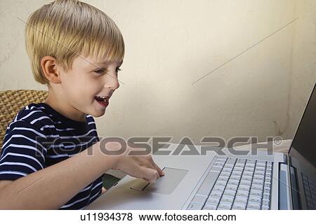 Stock Photo - Little Boy Using a Laptop. Fotosearch
