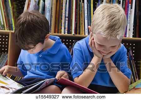 Stock Photo - Little Boys Reading Picture Books. Fotosearch