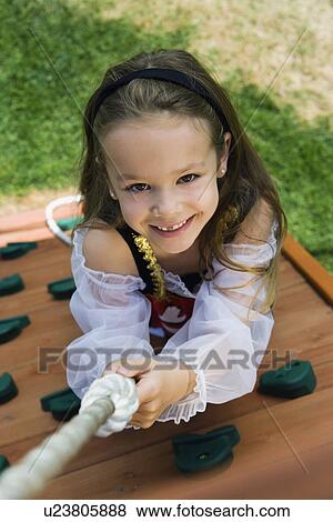 Stock Photo - Little Girl Climbing a Rope. Fotosearch