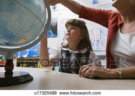 Stock Photo - Little Girl Learning Geography. Fotosearch