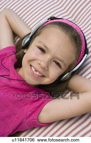 Little Girl Listening to Headphones View Large Photo Image Stock Photograph - Little Girl Listening to Headphones. Fotosearch