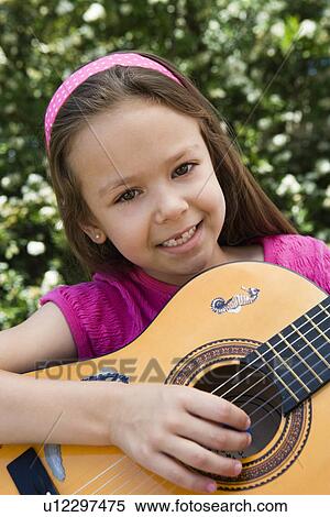 Stock Photography - Little Girl Playing Guitar. Fotosearch