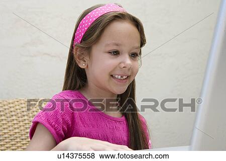 Stock Photo - Little Girl Using a Laptop. Fotosearch