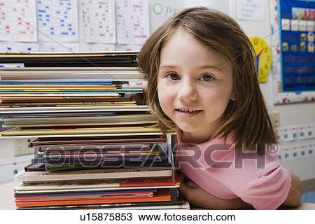 Stock Image - Little Girl with a Stack of Books. Fotosearch