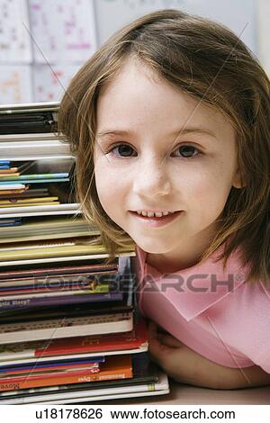 Little Girl with a Stack of Books View Large Photo Image Stock Photograph - Little Girl with a Stack of Books. Fotosearch
