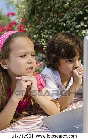 Little Kids Looking at a Laptop View Large Photo Image Stock Image - Little Kids Looking at a Laptop. Fotosearch