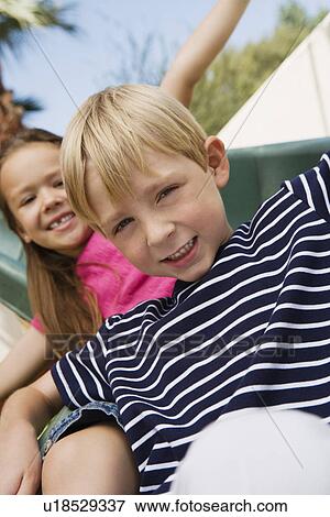Stock Photo - Little Kids on a Slide. Fotosearch