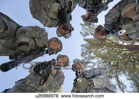 Stock Photo - Low angle portrait of armed soldiers. Fotosearch