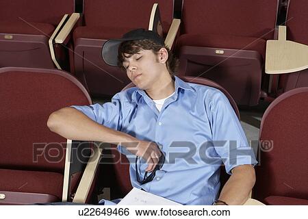 Stock Photograph - male college student sleeping in classroom. Fotosearch