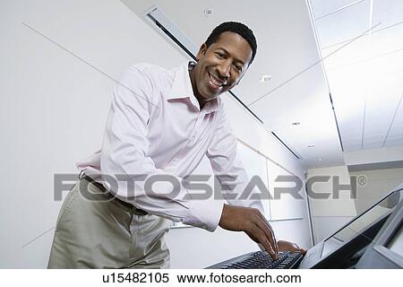 Male lecturer using computer View Large Photo Image Stock Photography - Male lecturer using computer. Fotosearch