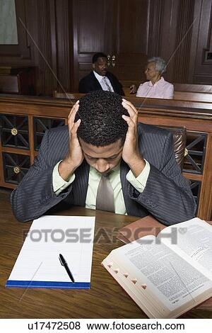 Stock Photo - Male solicitor working in court. Fotosearch