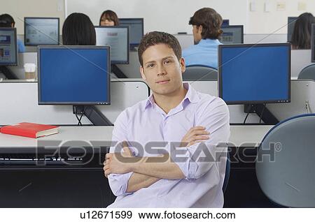 Male student sitting in computer classroom, portrait View Large Photo Image Stock Photo - Male student sitting in computer classroom, portrait. Fotosearch