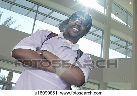 Male student smiling, indoors, portrait View Large Photo Image Stock Image - Male student smiling, indoors, portrait. Fotosearch