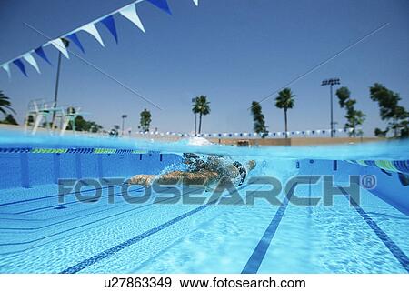 Stock Photo - Male swimmer in pool, surface view. Fotosearch