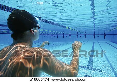 Picture - Male swimmer wearing United States swimming cap in pool. Fotosearch