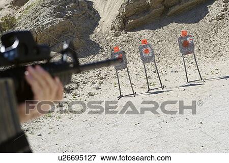 Man aiming machine gun at firing range, close up of hands View Large Photo Image Stock Photo - Man aiming machine gun at firing range, close up of hands. Fotosearch