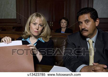Stock Photography - Man and woman sitting in court, portrait. Fotosearch