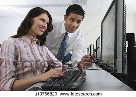 Man and woman using computer together View Large Photo Image Stock Image - Man and woman using computer together. Fotosearch