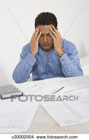Picture - Man Anxious over Personal Finances. Fotosearch