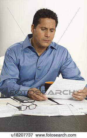 Stock Photo - Man Doing Personal Finances. Fotosearch