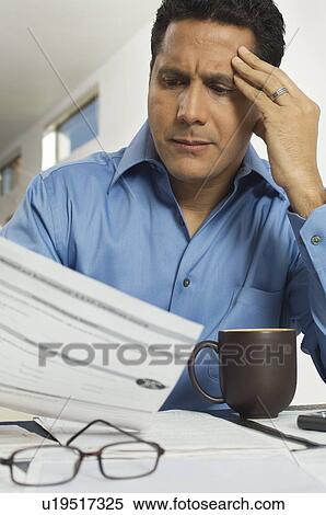 Stock Photography - Man Doing Taxes. Fotosearch
