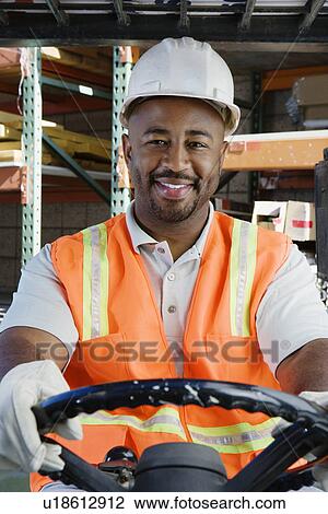 Stock Image - Man Driving a Forklift. Fotosearch