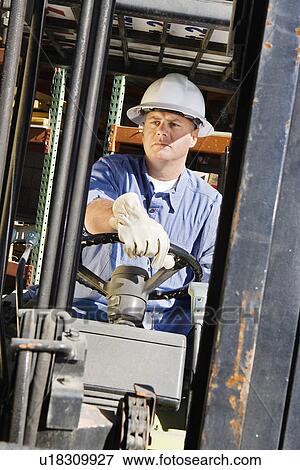 Stock Photo - Man Driving a Forklift. Fotosearch